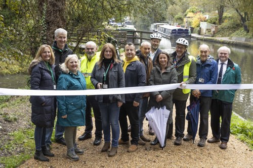 A group of people stood on the canal towpath